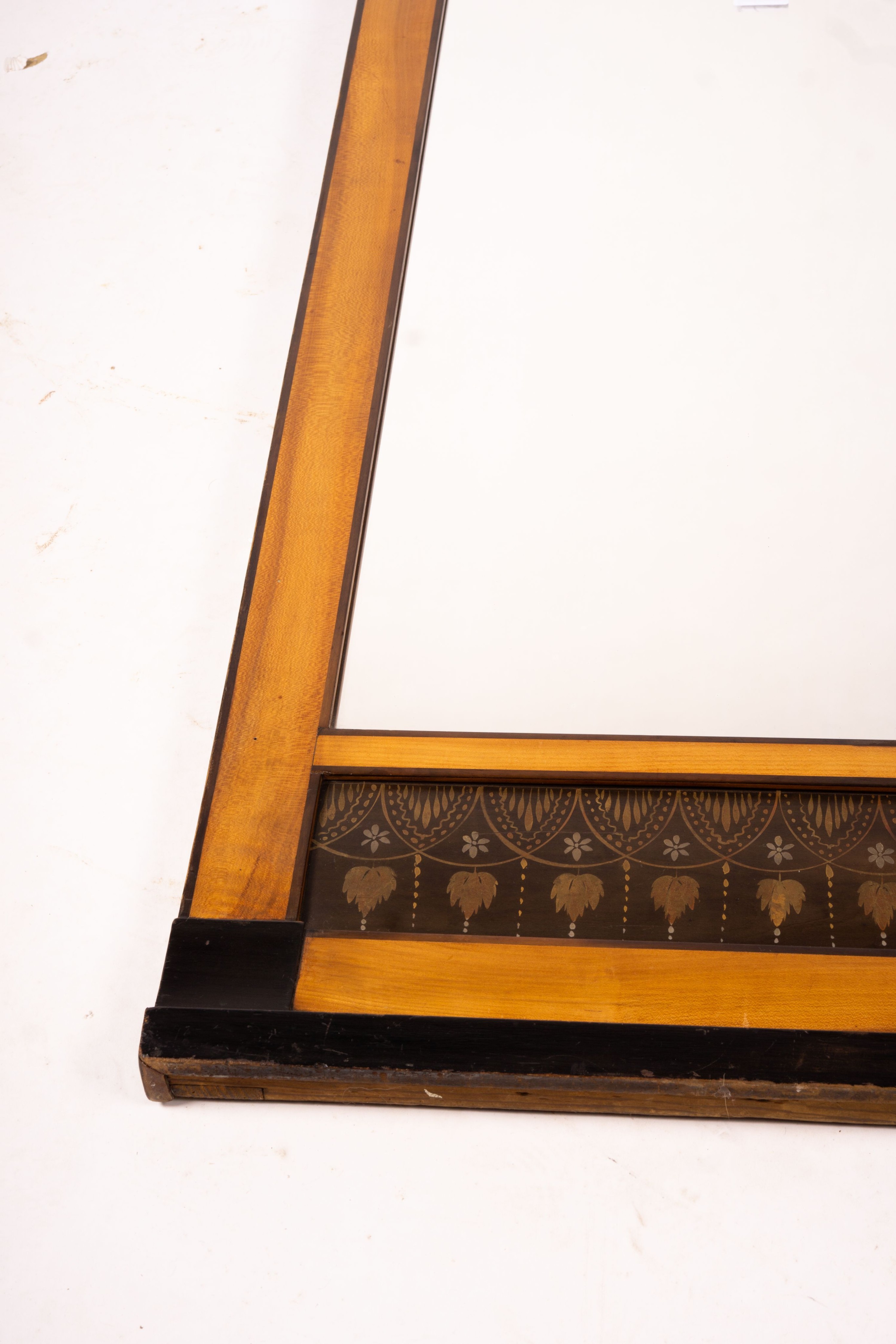 A Biedermeier style mirror with stencil decoration, width 51cm, height 109cm